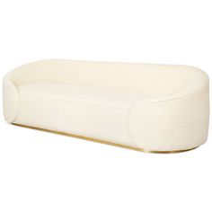 a white couch sitting on top of a wooden table