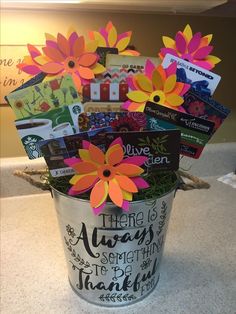 a bucket filled with lots of cards and flowers