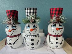 three snowmen sitting on top of a table