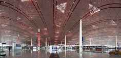 the inside of an airport with people walking around