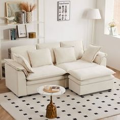 a living room with a sectional couch and coffee table on the rug in front of it