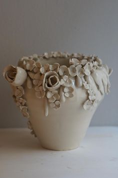 a white vase sitting on top of a table