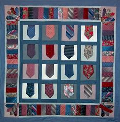 a quilted wall hanging with ties on it