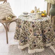 a table topped with a bowl of fruit next to a chair