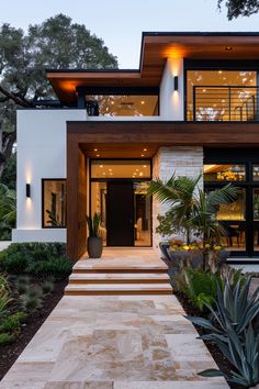 a modern house with large steps leading up to the front door