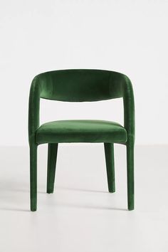 a green chair sitting on top of a white floor