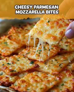 cheesy parmesan mozzarella bites being lifted from a baking dish