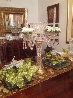 the centerpieces are decorated with white flowers and greenery in glass vases