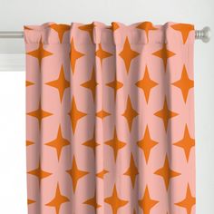 an orange and white curtain with stars on it