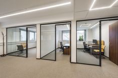 an empty office with glass walls and sliding doors