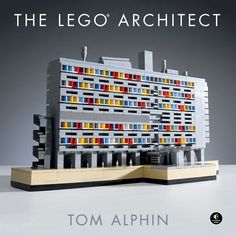 the lego architecture book is on display in front of a gray background with an image of a building