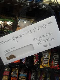 a sign that is on the side of a vending machine saying random act of kindness