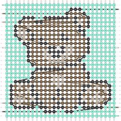 a cross stitch teddy bear sitting on top of a blue and green background with circles