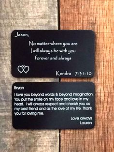 two magnets with words on them sitting next to each other in front of a wooden surface