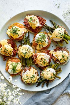 a white plate topped with eggs and asparagus