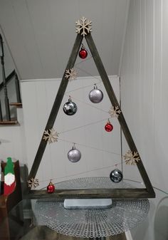 a christmas tree made out of wood and ornaments