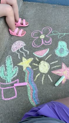 a child's drawing on the sidewalk with crayons