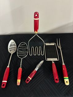 the kitchen utensils are lined up on the table next to the cooking utensils