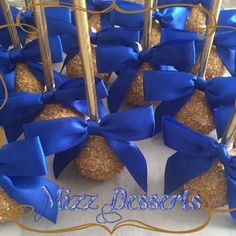 a bunch of cookies with blue bows on them