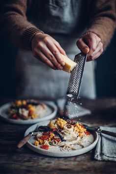 a person grating cheese on top of some food