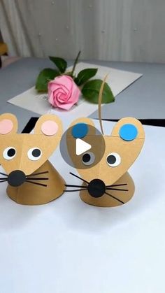 two paper mouses sitting on top of a table