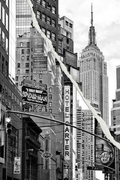 black and white photograph of city street with buildings in the background, including tall skyscrapers