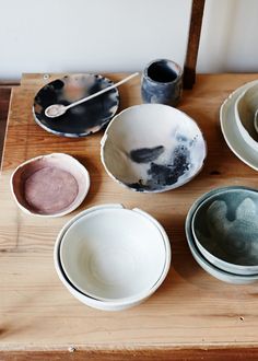 bowls and spoons are sitting on a table