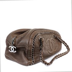 This Chanel Bronze Luxe Ligne Bowler Bag is in excellent condition from the 2006 collection. Perfectly scaled for every day enjoyment, the neutral color and exposed chain details make this Chanel a chic companion. Subtle metallic bronzy brown textured leather with silver hardware accents. Large interlocking CC is tonally stitched on the front. Exposed silver chain is uniquely woven into the design. Top zipper accesses the clean beige interior. Double straps are comfortably carried on the shoulde Bowler Bag, Beige Interior, Brown Texture, Mode Inspo, Neutral Color, Fashion Killa, Silver Hardware