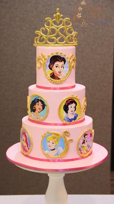 a three tiered cake with princess pictures on it