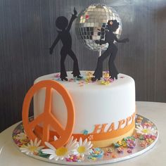 there is a cake decorated with people and a disco ball