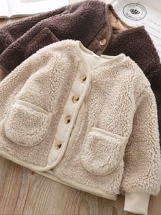 So fuzzy and adorable! Your little darling will just love cozying up in this fuzzy wool jacket that will complete her winter wardrobe. Perfect for layering over her favorite cold-weather outfits. Comfort is guranteed with its super soft fabric that’s made to provide extra warmth during chilly days. Side pocket details for storing small essentials, candies, and other treasures Perfect for fall, winter, holiday looks, and fashion photoshoots Fleece wool jacket with side pocket details Available in Outerwear Details, Sherpa Cardigan, Denim Baby, Winter Outfits For Girls, Clothes For Girls, Warm Cardigan, Soft Jacket, Korean Boys, Girls Cardigan