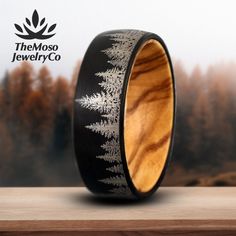 a wooden ring with an intricate design inlayed to the inside is on top of a table