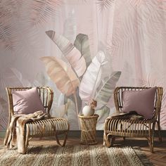 two wicker chairs in front of a tropical wallpaper