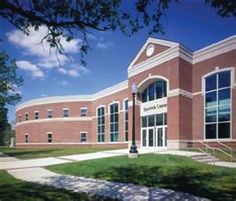 a large brick building sitting on top of a lush green field