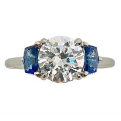 Bringing art deco to the modern world, this stunning mounting features Cadillac cut sapphires and hidden diamond halos.Clearance Item. All Sales Final. Clearance items are not eligible for return.- PRICE IS FOR THE MOUNTING ONLY AND DOES NOT INCLUDE THE CENTER STONE.- PLATINUM.- BLUE SAPPHIRES.- SAPPHIRE WEIGHT: 0.65 CT.- FOR CENTER STONE SIZE: 1.50 CT - 7.5 MM ROUND - SETTING DIAMOND WEIGHT: 0.10 CTW.- FINGER SIZE: 6.5.- Please call one of our Diamond Specialists to help you choose the perfect Diamond And Sapphire Ring, Estate Diamond Jewelry, Semi Mount Ring, Retro Jewelry, Hidden Halo, Sapphire Diamond, Say Yes, Halo Diamond, Diamond Rings