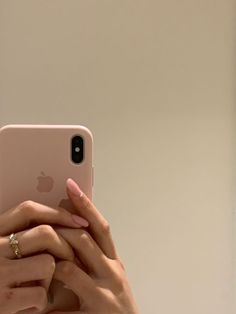 a close up of a person holding an iphone