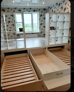 two empty beds in a room with open drawers