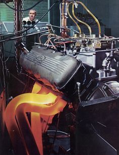 a man working on an engine in a factory