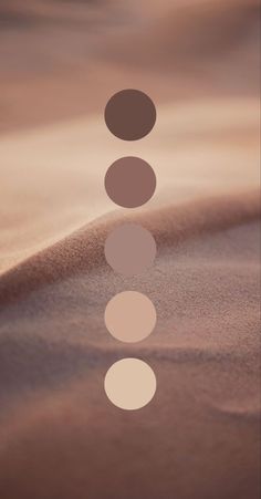 three circles are arranged in the shape of a line on top of a sand dune