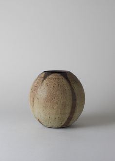 a brown vase sitting on top of a white table