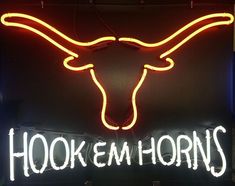 This Hook Em Horns Neon Sign measures 31 inches wide and 24 inches tall and features the University of Texas Longhorns logo in orange and white colored neon glass tubing with the words "HOOK EM HORNS" at the bottom. This sign makes a great gift for fans of the Texas Longhorns as well as makes a great wall decoration for sports bars and restaurants. Texas University Longhorns, Ut University, Football Man Cave, Texas Longhorns Logo, Football Man