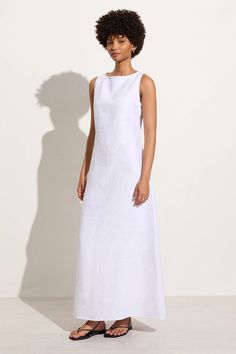 The Nahna Maxi Dress in White is a sleeveless full length dress mindfully made from responsibly sourced linen. Designed with a tailored A-line silhouette, high boat neckline and back rope ties with a twisted detail. The Nahna will take you from beach to bar and beyond with ease. White Dress Linen, Modest White Dress, High Neck White Dress, Maxi Dress Linen, Linen Summer Dress, Gathered Top, Maxi Shift Dress, Maxi Dress White, Party Aesthetic