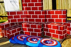 some red bricks are stacked on top of each other with captain's shield painted on them