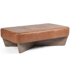 a brown leather bench sitting on top of a white floor