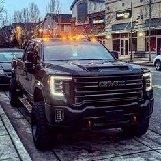 a black truck parked on the side of a street