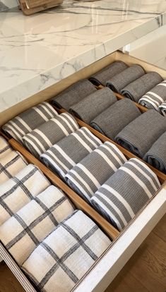 the drawers are filled with towels and folded ones in black and white checkered fabric