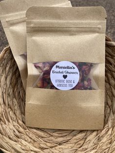 two bags of dried flowers sitting in a basket