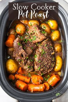 slow cooker pot roast with carrots, potatoes and meat in the crockpot