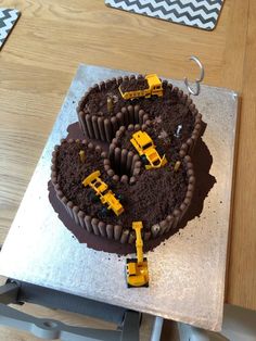 there is a cake with construction trucks on it