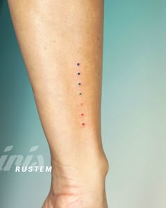 a person's foot with dots on it and the word rusttem written in white ink